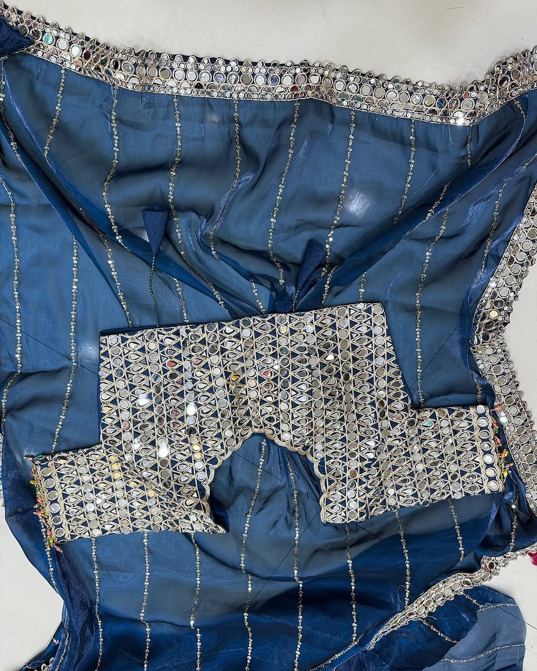 Soft satin Organza saree which is embedded with real mirror work
