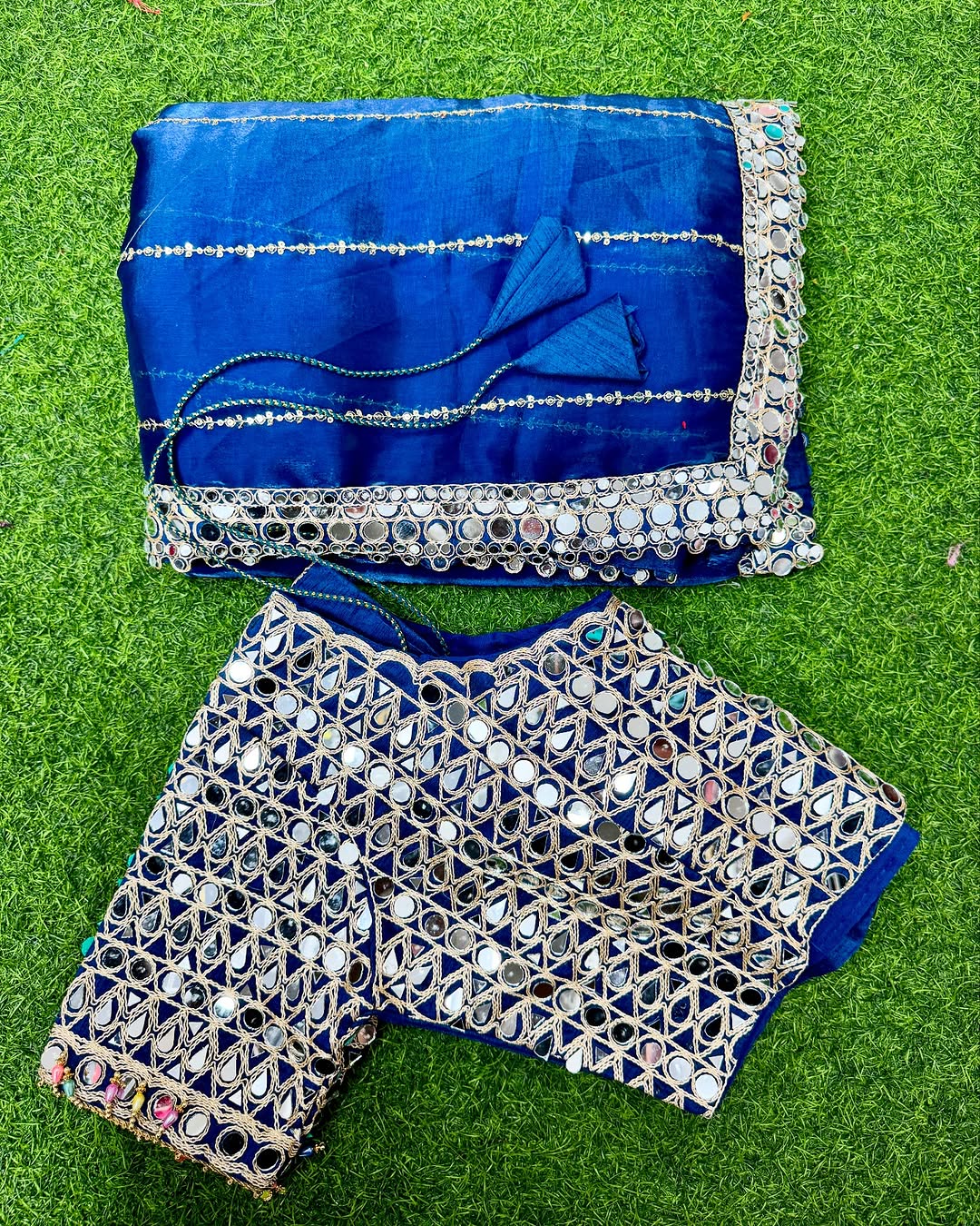 Soft satin Organza saree which is embedded with real mirror work