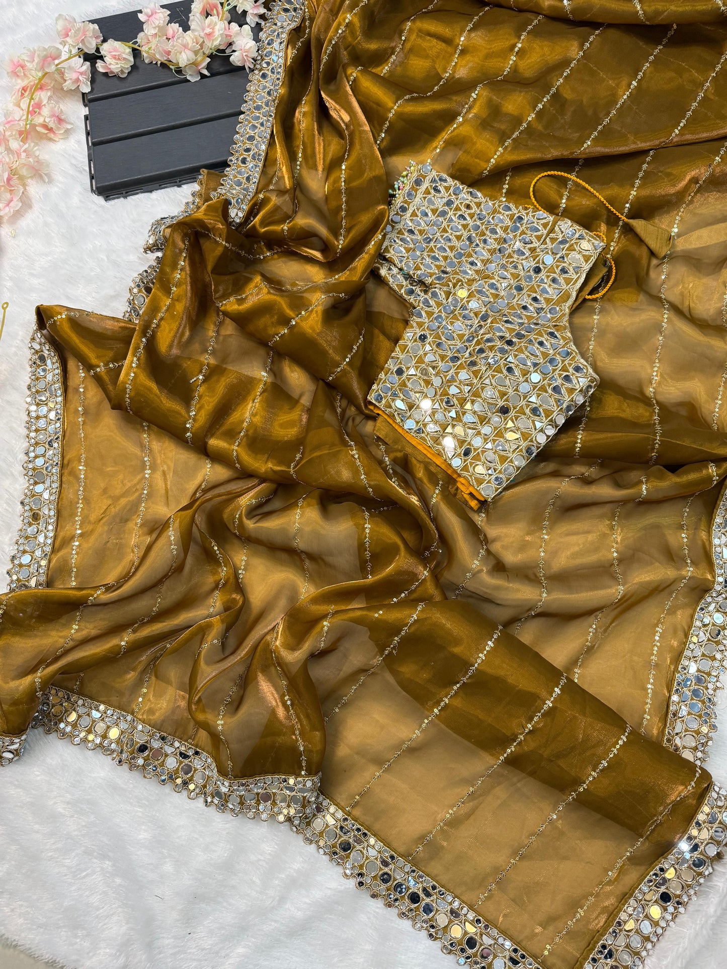 Soft satin Organza saree which is embedded with real mirror work