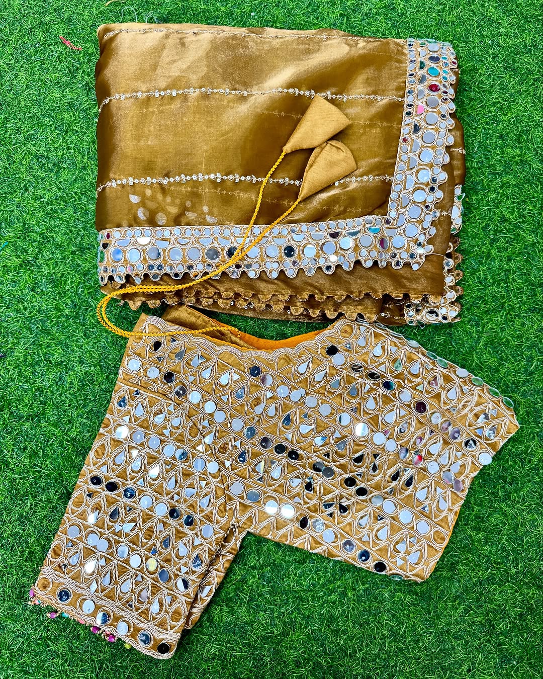 Soft satin Organza saree which is embedded with real mirror work