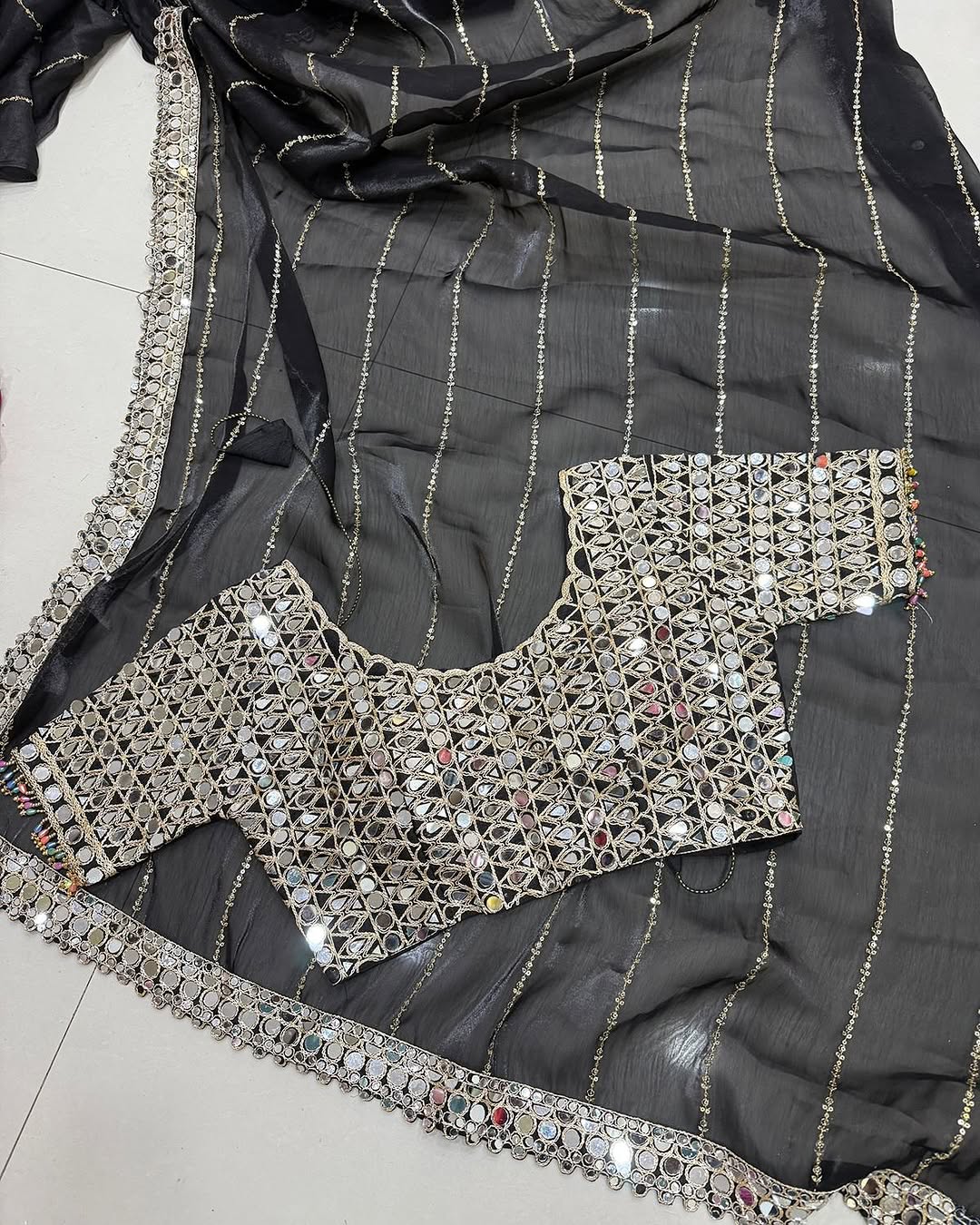Soft satin Organza saree which is embedded with real mirror work