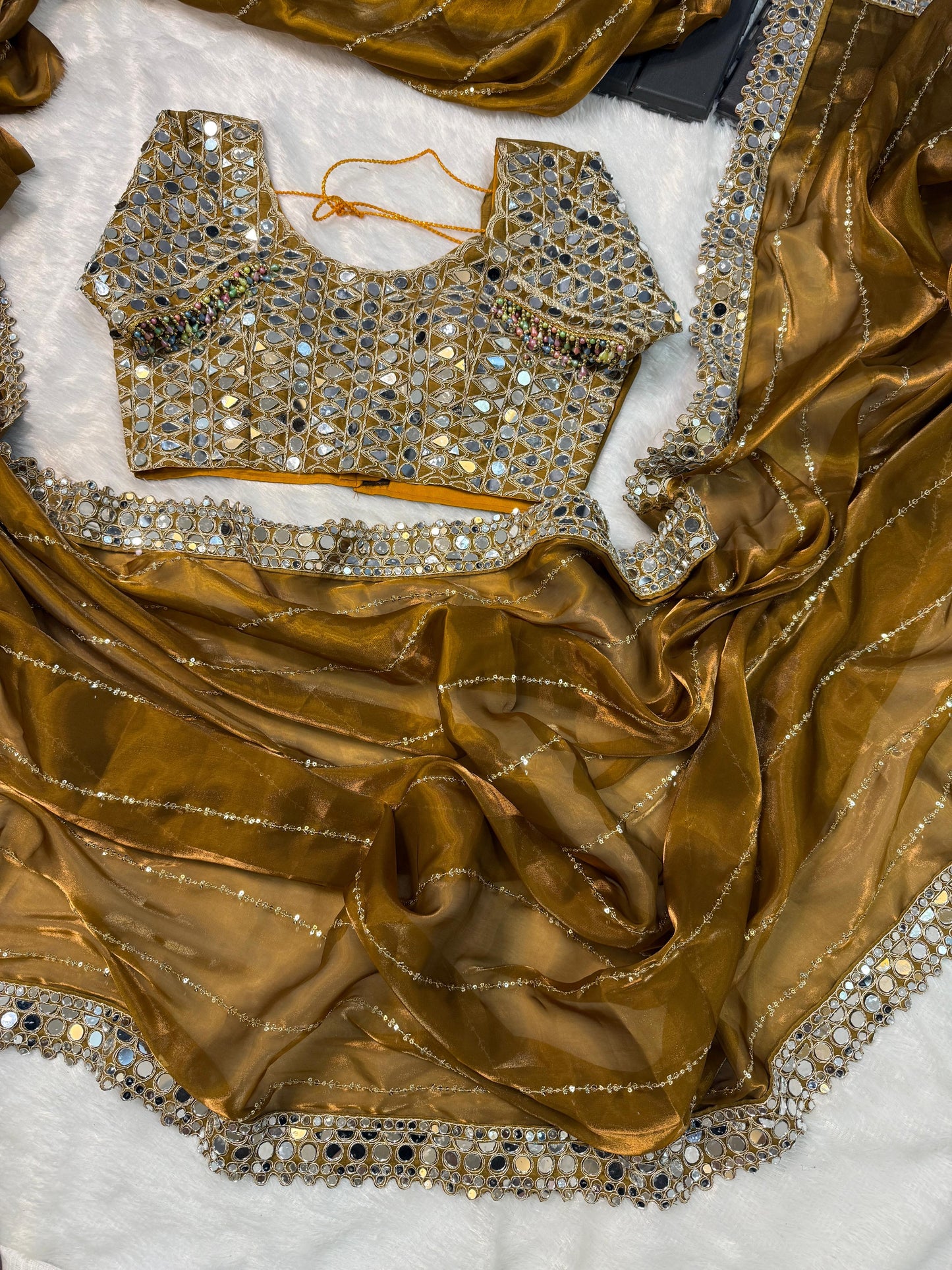 Soft satin Organza saree which is embedded with real mirror work