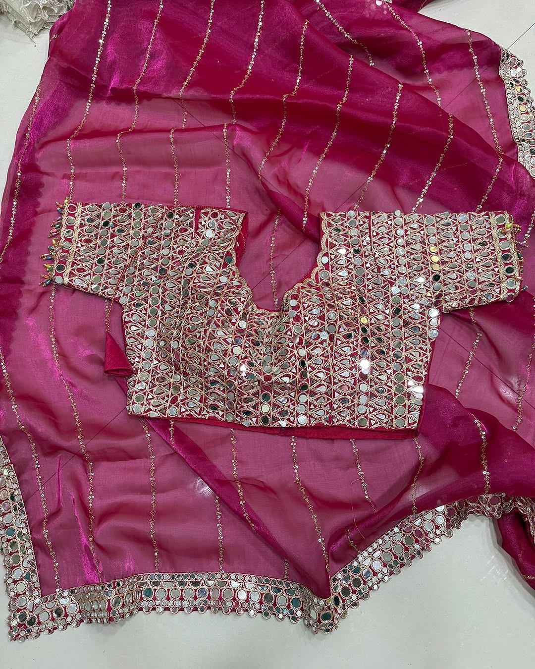 Soft satin Organza saree which is embedded with real mirror work