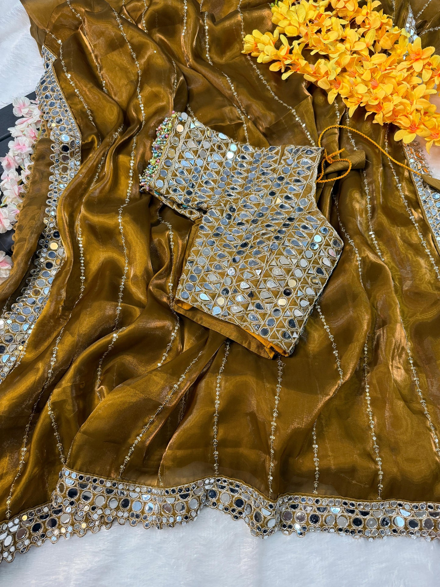 Soft satin Organza saree which is embedded with real mirror work